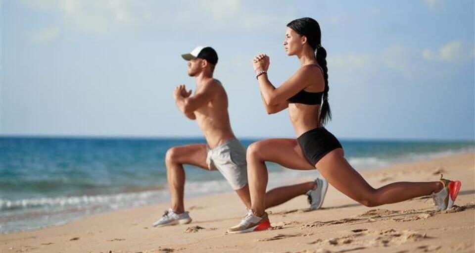 Couple training on the beach